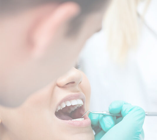 Dentist examining patient using mouth mirror