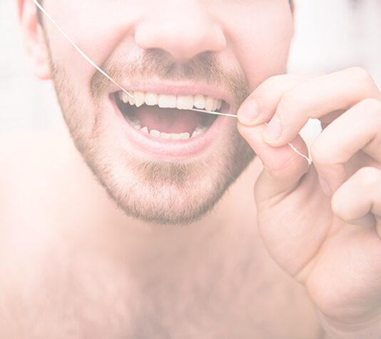 Man using dental floss